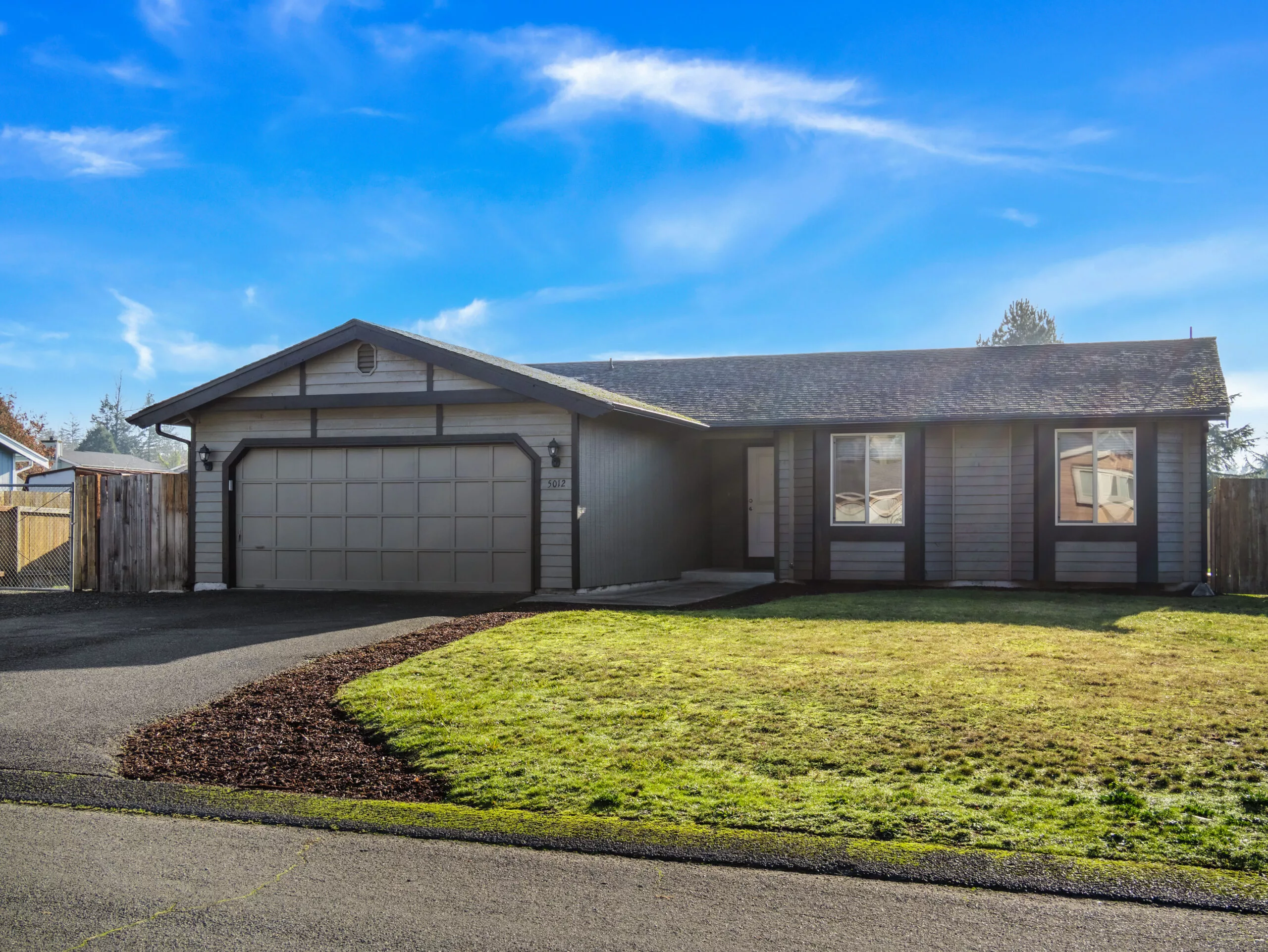 A front-facing photo of the exterior of 5012 216th Street Ct E, an updated one-level home in Spanaway.