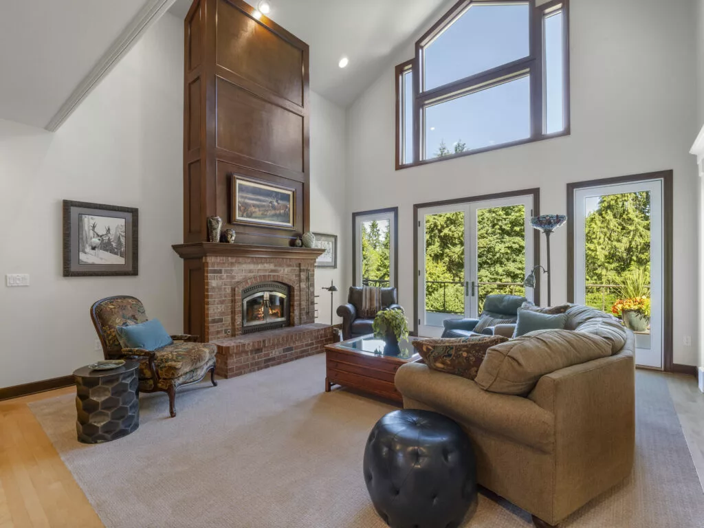 An interior living room photo of a high-end house that was listed by the Cascade Property Advisers, featuring cathedral ceilings and natural lighting.