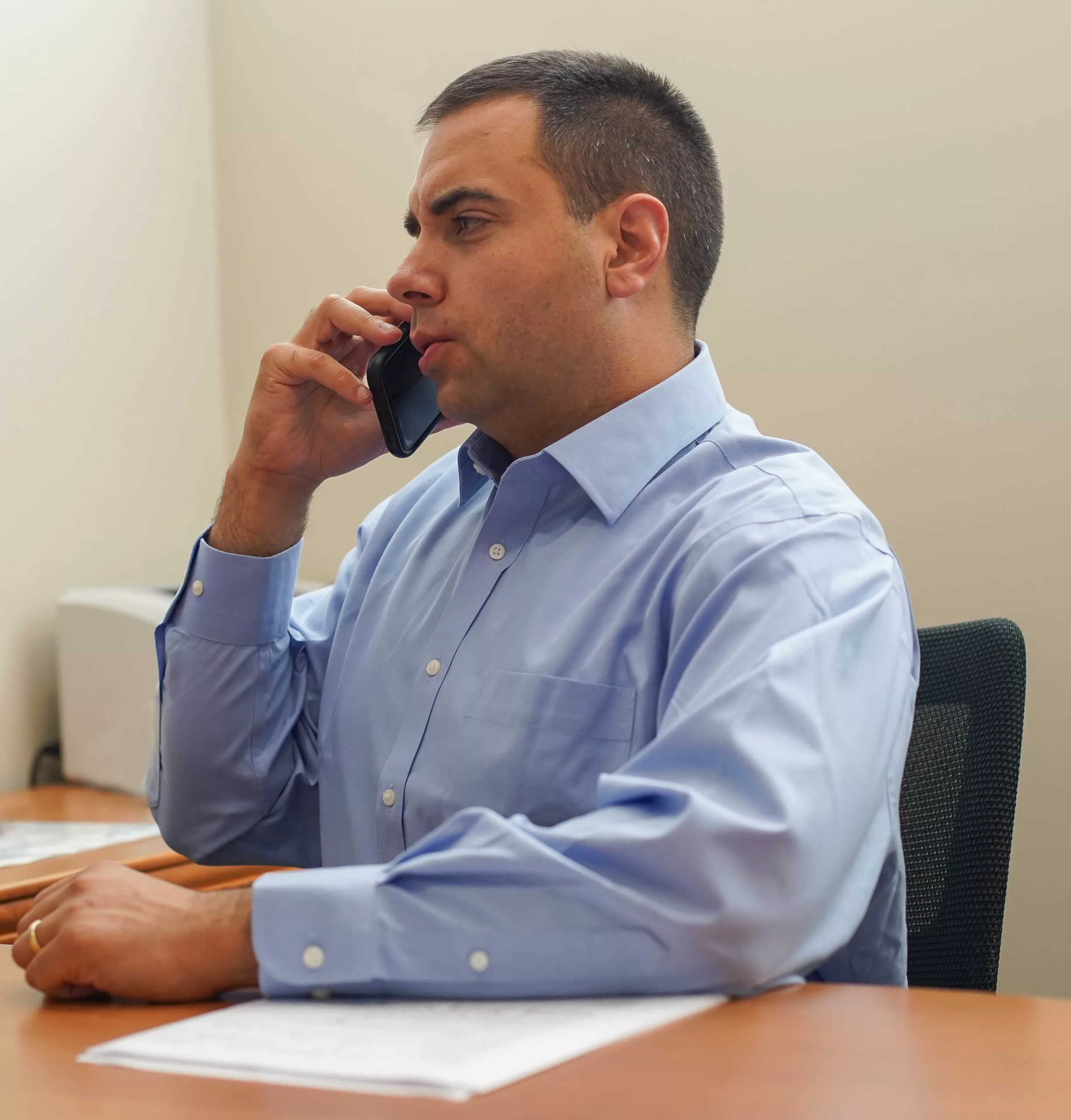 Anders Ibsen taking a phone call at a desk, responding promptly to a client.