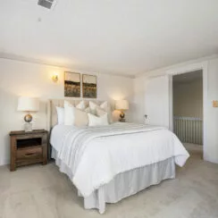 Primary bedroom, with staged furniture and new carpet.