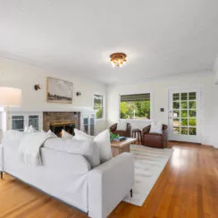 View of the living room with restored hardwood flooring.