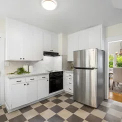 View of the kitchen, with new granite countertops, cabinets, and appliances.