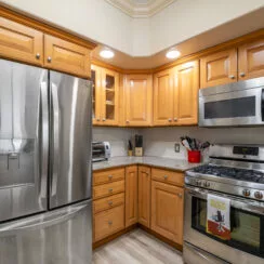 Second photo of the kitchen, with a more detailed look at the stainless steel appliances.