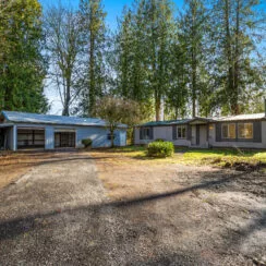 A front-facing photo of the exterior of 150 Jorgensen Rd, a home on acreage and near a river near the town of Onalaska.