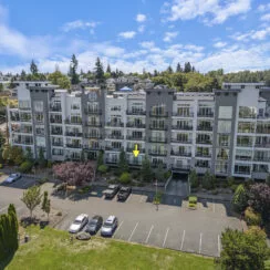 An exterior photo of the condo building, with an arrow pointing to the specific location of unit #108 so you can see where it is.