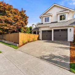 Front exterior of the home, farther from the street to the driveway.