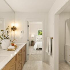 Exiting the primary bathroom back into the en suite.
